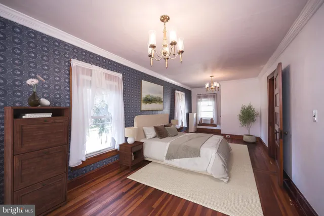 a spacious bedroom with a large bed and a chandelier