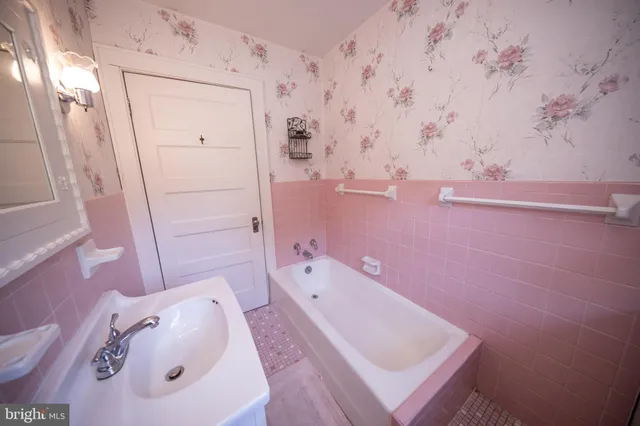 a bathroom with a tub a sink and a toilet