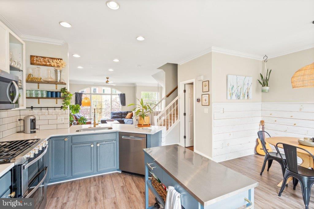 10136 Pale Rose Loop Bristow, VA 20136 - Photo 19 of 66 a kitchen with a table chairs stove and cabinets