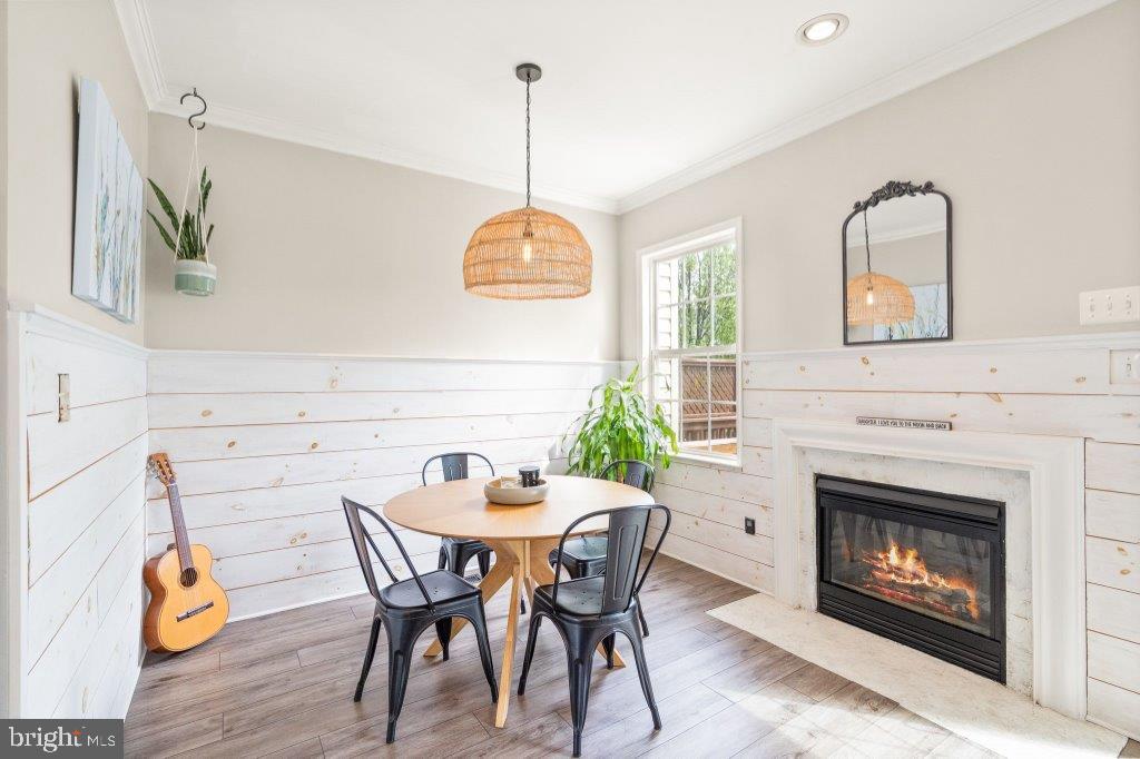 10136 Pale Rose Loop Bristow, VA 20136 - Photo 22 of 66 a view of a dining room with furniture window and wooden floor