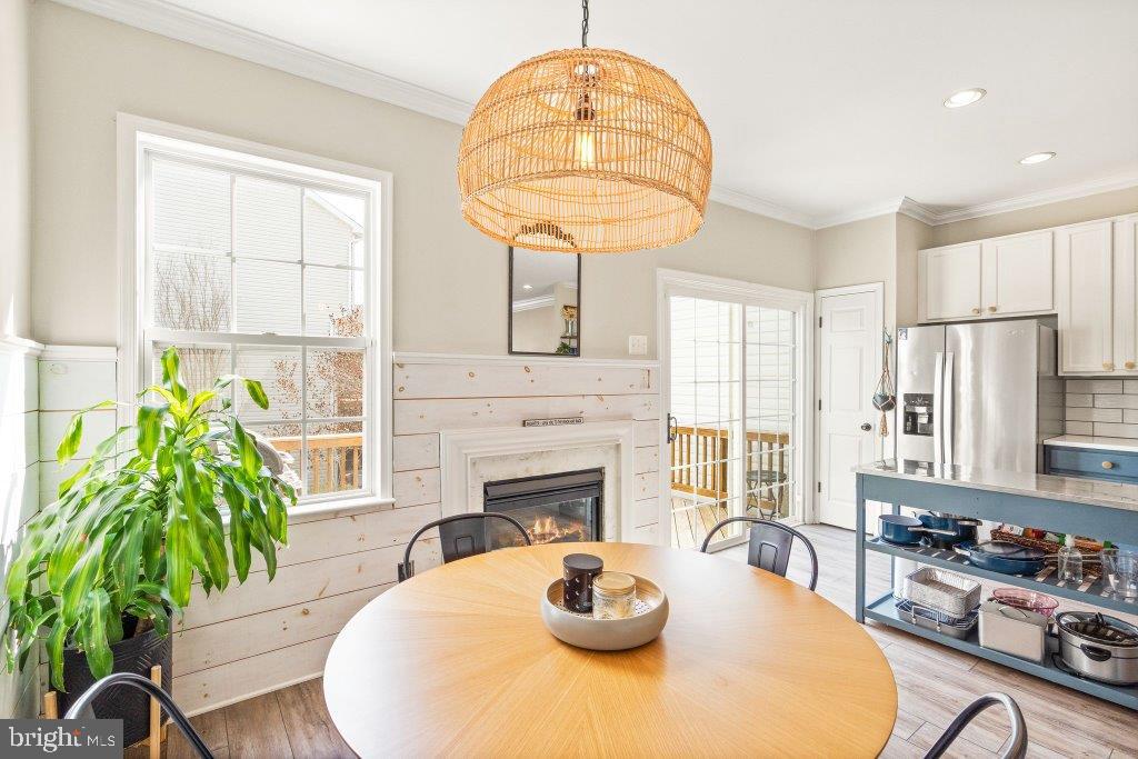 10136 Pale Rose Loop Bristow, VA 20136 - Photo 25 of 66 a living room with furniture a chandelier and a fireplace