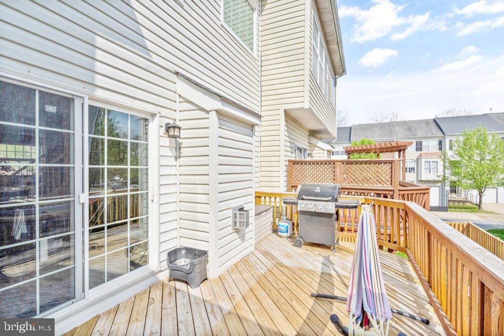 10136 Pale Rose Loop Bristow, VA 20136 - Photo 28 of 66 a view of a balcony with wooden floor and iron fence