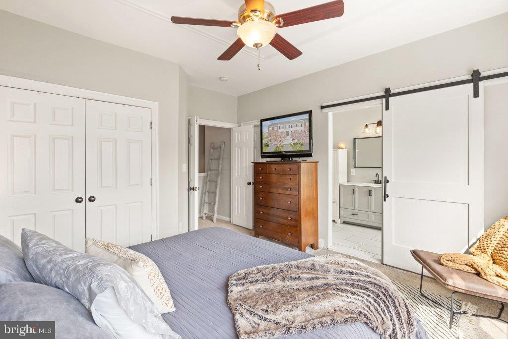 10136 Pale Rose Loop Bristow, VA 20136 - Photo 34 of 66 a bedroom with a bed and a chandelier