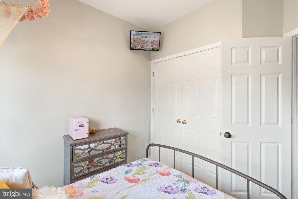 10136 Pale Rose Loop Bristow, VA 20136 - Photo 45 of 66 a bedroom with a bed and a dresser in it