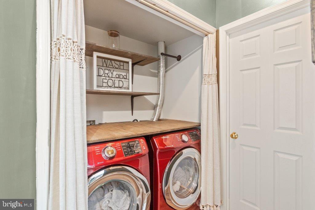 10136 Pale Rose Loop Bristow, VA 20136 - Photo 51 of 66 a utility room with dryer and washer