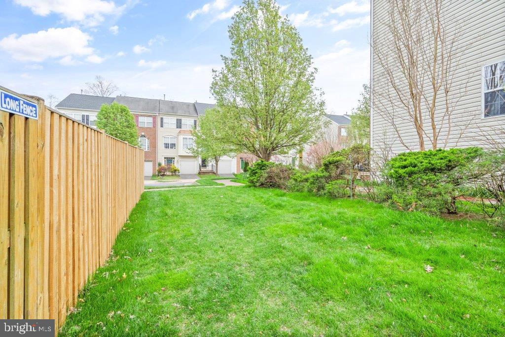 10136 Pale Rose Loop Bristow, VA 20136 - Photo 56 of 66 a view of a house with a yard and pathway
