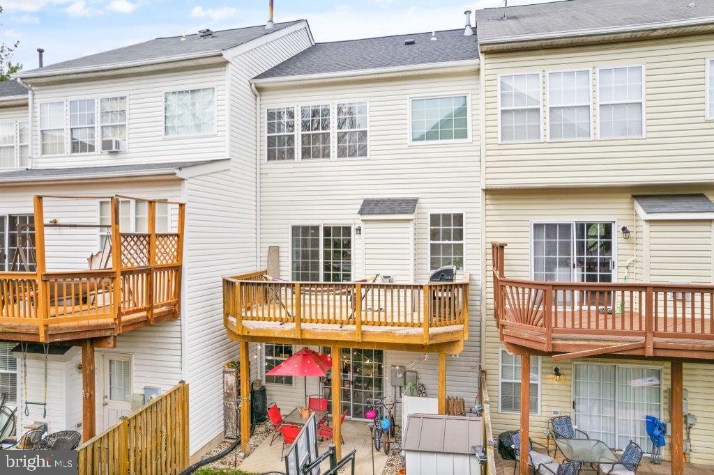 10136 Pale Rose Loop Bristow, VA 20136 - Photo 58 of 66 a front view of a building with glass windows