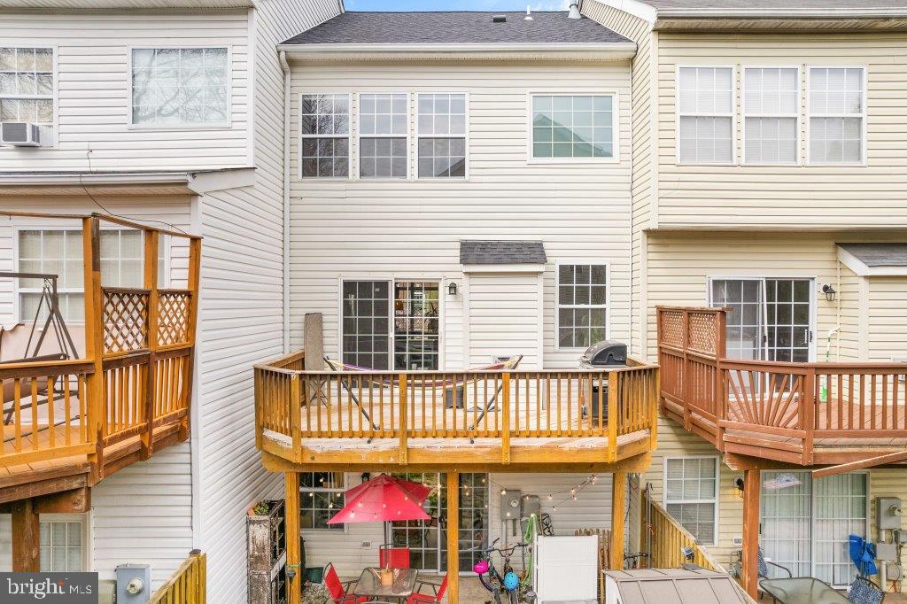 10136 Pale Rose Loop Bristow, VA 20136 - Photo 59 of 66 a front view of a house with a roof deck