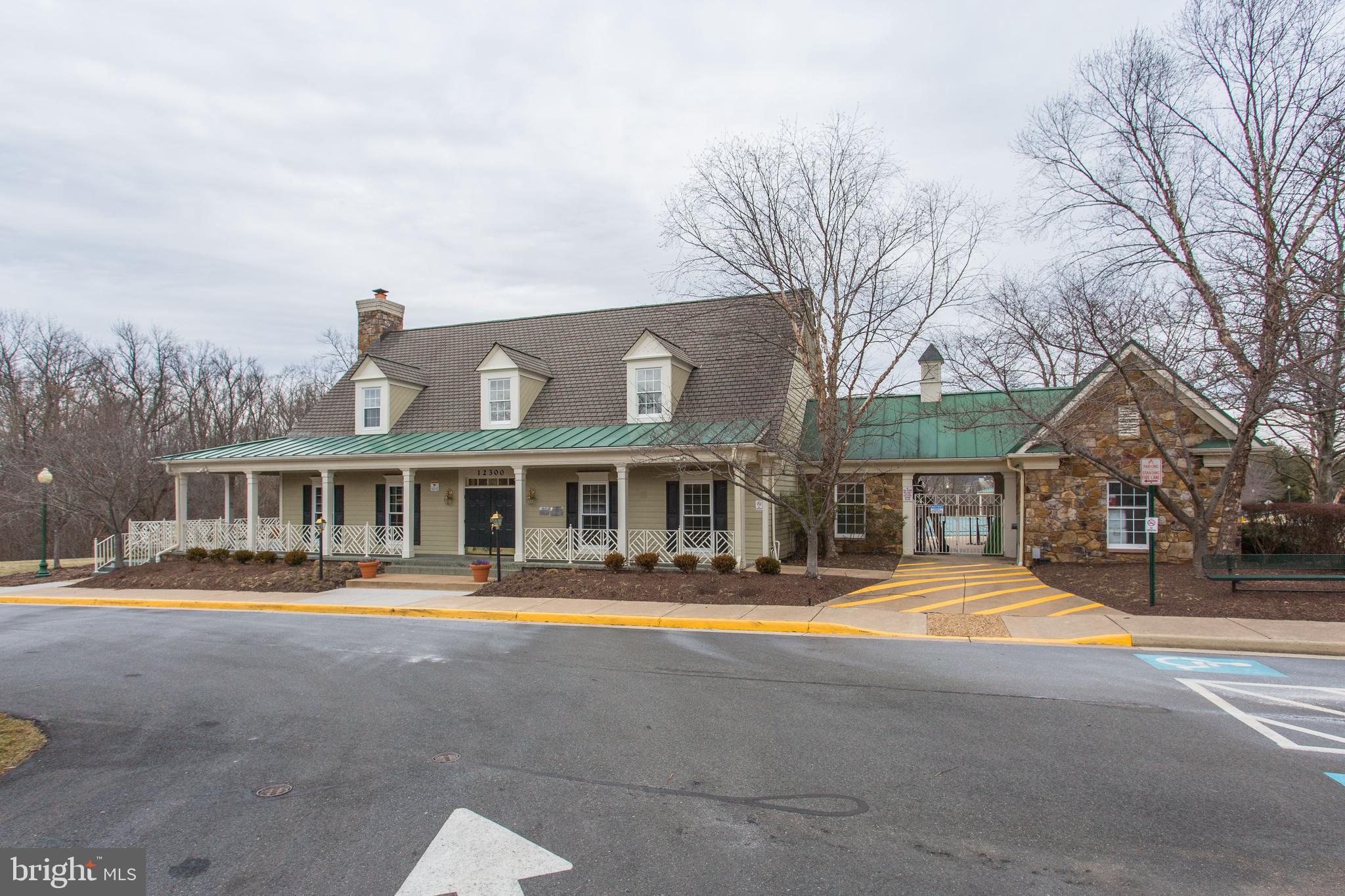 10136 Pale Rose Loop Bristow, VA 20136 - Photo 61 of 66 a front view of building with small garden and trees