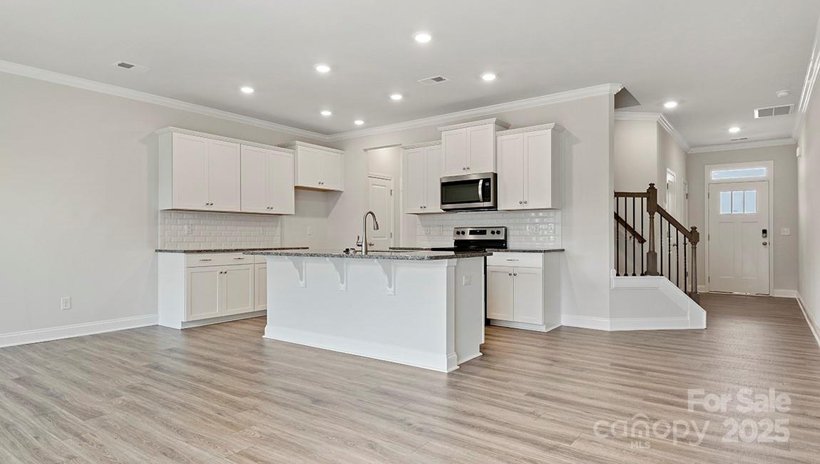 351 Lagoon Road Fletcher, NC 28732 - Photo 4 of 21 a kitchen with granite countertop a stove a sink and a refrigerator