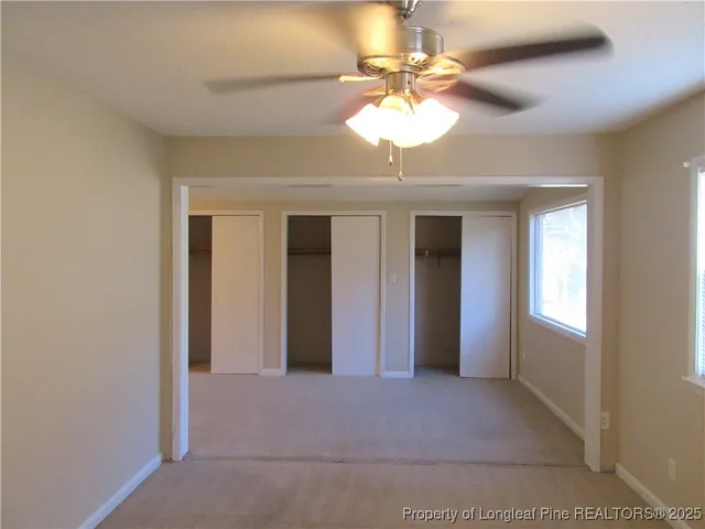 a view of a livingroom with a chandelier fan