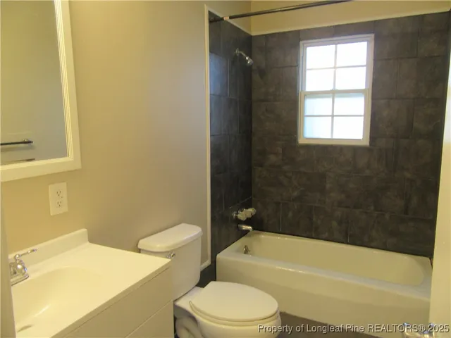 a bathroom with a toilet a sink and bathtub