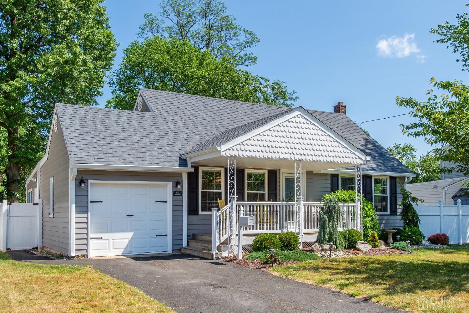 40 Longfellow Drive Colonia, NJ 07067 - Photo 1 of 24 a front view of a house with garden
