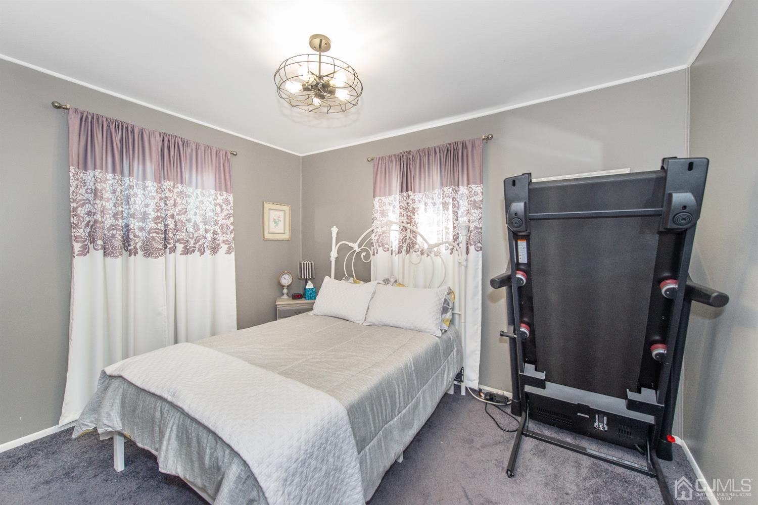 40 Longfellow Drive Colonia, NJ 07067 - Photo 12 of 24 a bedroom with a bed and a chandelier