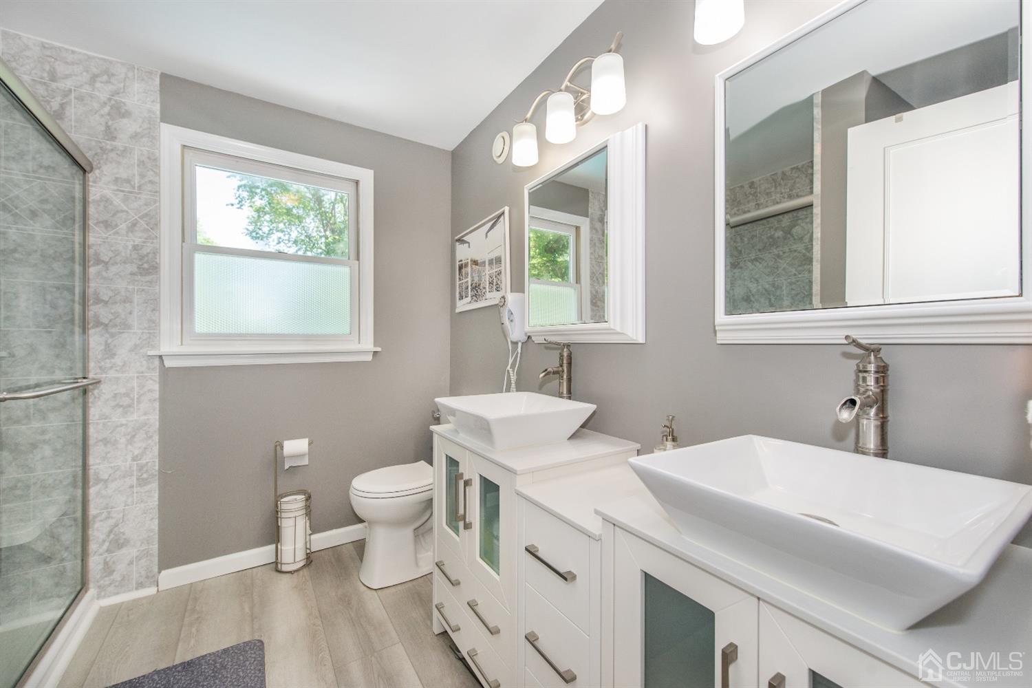 40 Longfellow Drive Colonia, NJ 07067 - Photo 15 of 24 a bathroom with a sink a toilet and a window