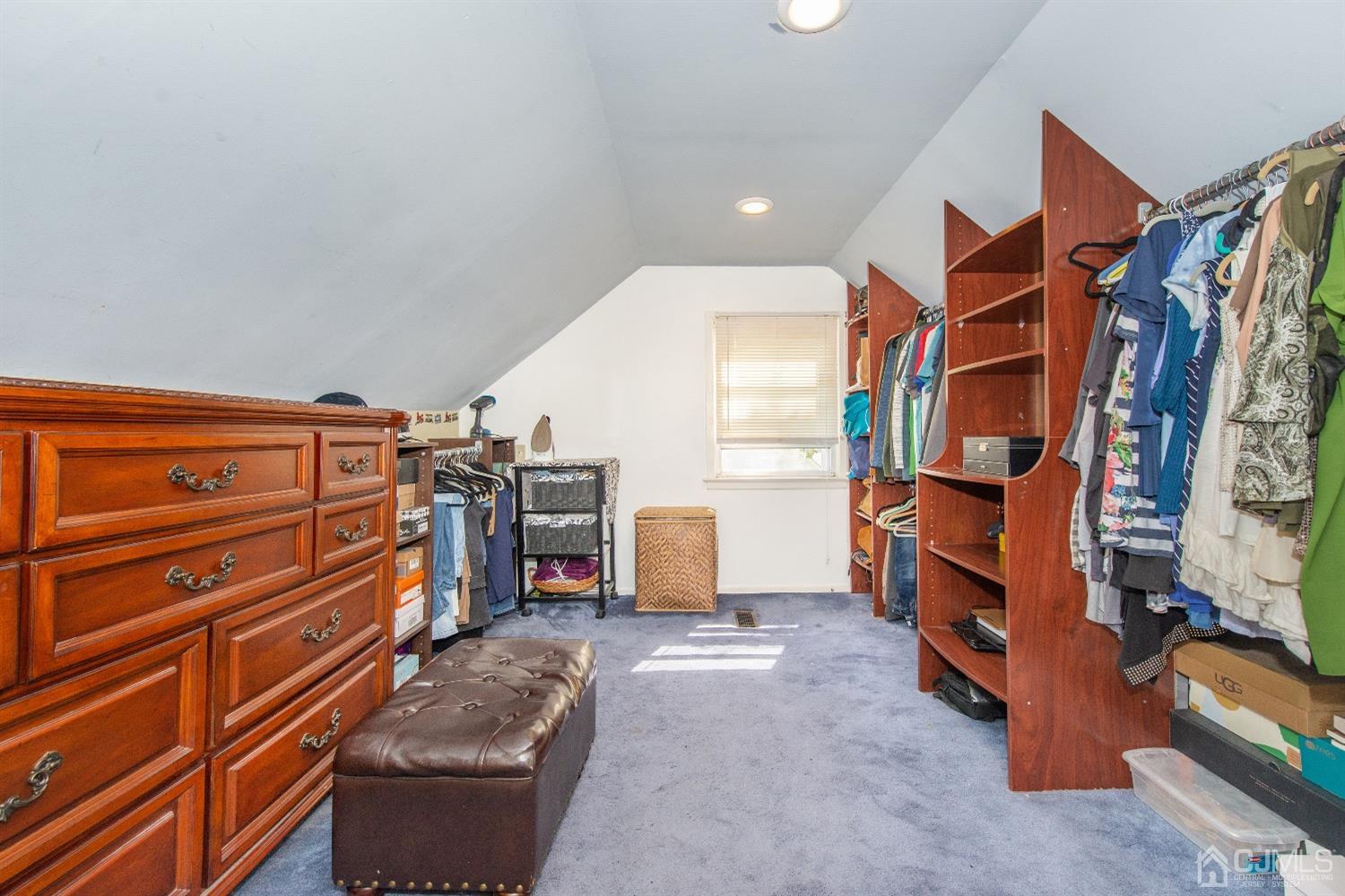 40 Longfellow Drive Colonia, NJ 07067 - Photo 16 of 24 a view of walk in closet with clothes and shoes