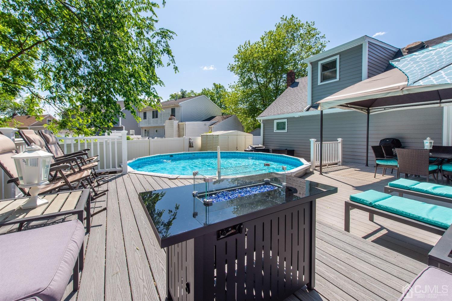 40 Longfellow Drive Colonia, NJ 07067 - Photo 20 of 24 a view of a patio with table and chairs with wooden floor and fence