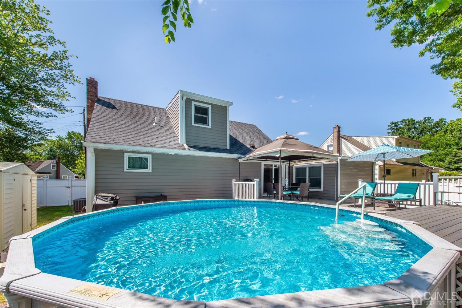 40 Longfellow Drive Colonia, NJ 07067 - Photo 22 of 24 a front view of a house with a yard table and chairs