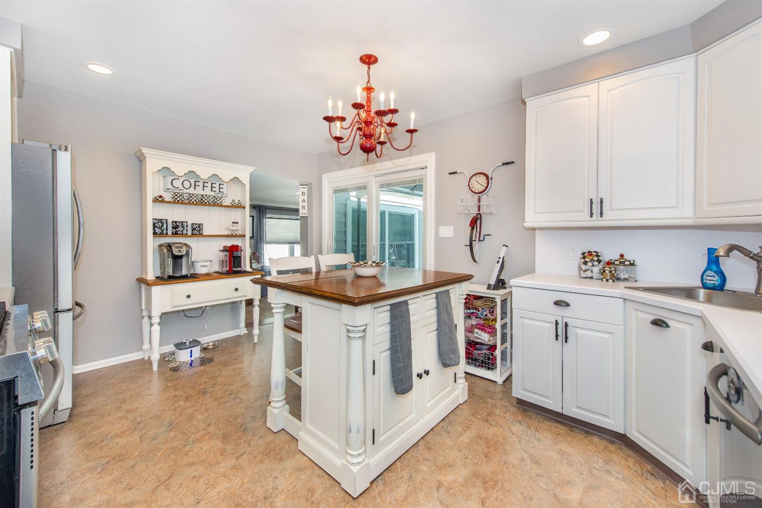 40 Longfellow Drive Colonia, NJ 07067 - Photo 6 of 24 a kitchen filled with white cabinets and white appliances