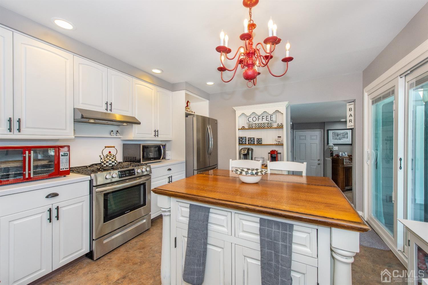 40 Longfellow Drive Colonia, NJ 07067 - Photo 7 of 24 a view of a kitchen with kitchen island a sink and a stove