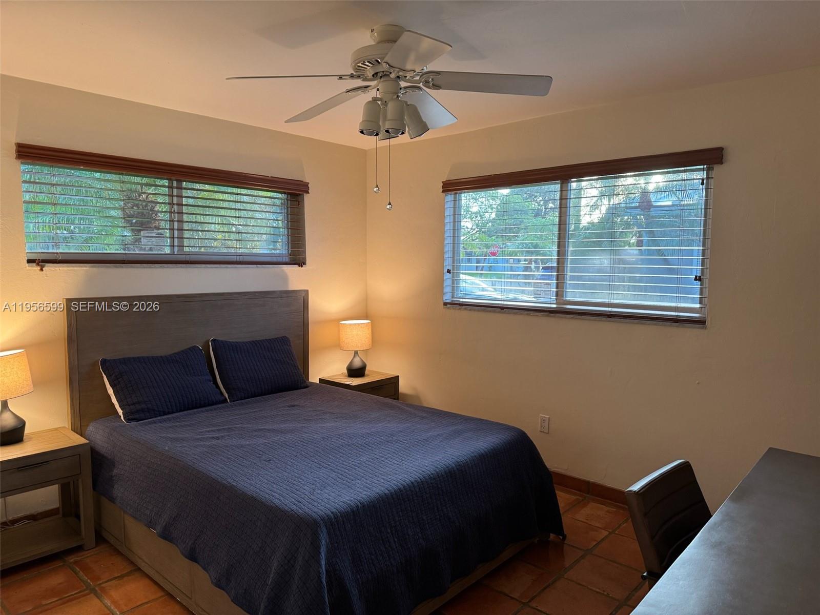 1110 Redbird Avenue Miami Springs, FL 33166 - Photo 19 of 25 a bedroom with a bed and a fireplace