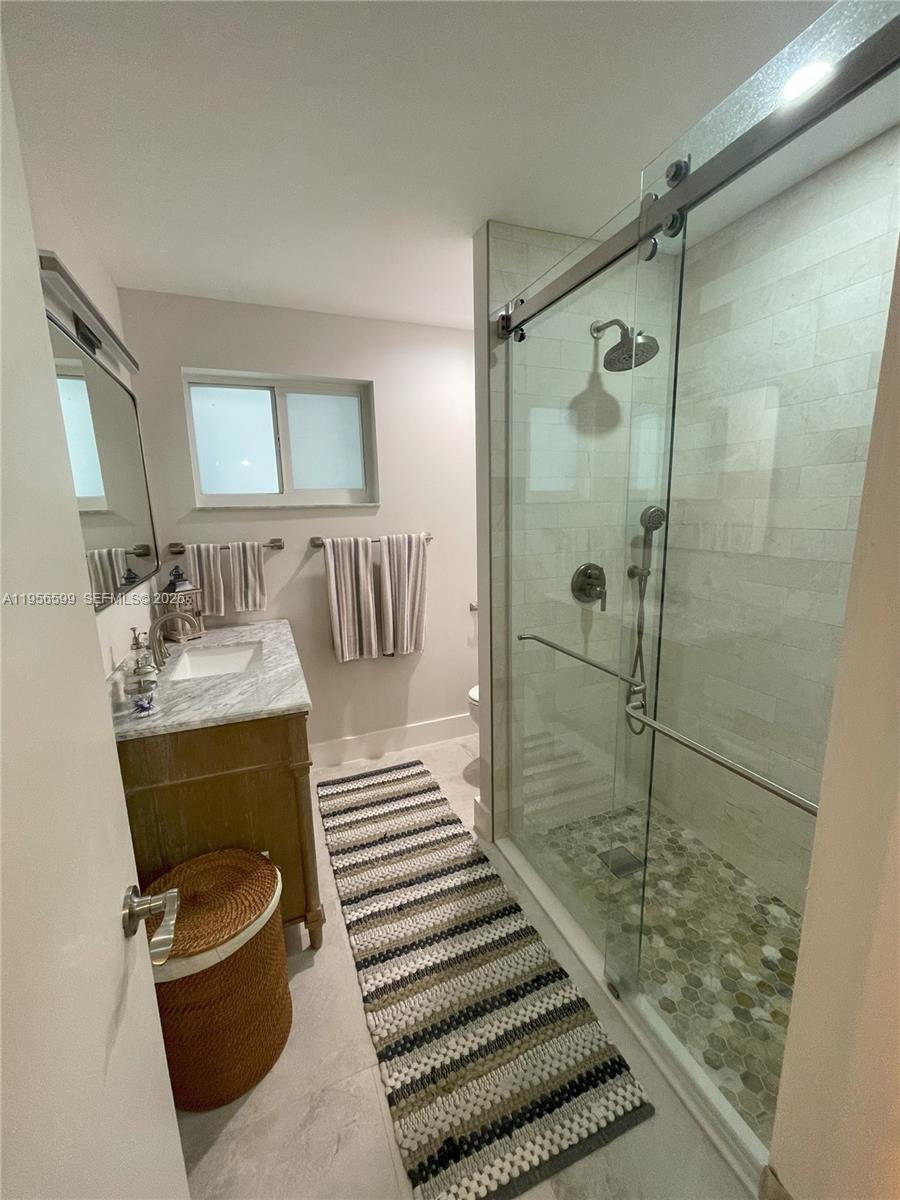 1110 Redbird Avenue Miami Springs, FL 33166 - Photo 21 of 25 a bathroom with a sink a toilet and shower