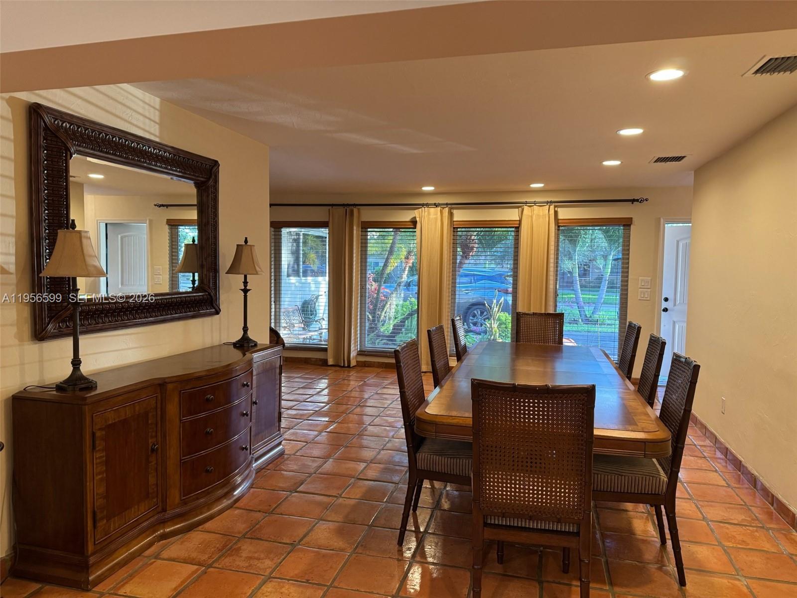 1110 Redbird Avenue Miami Springs, FL 33166 - Photo 8 of 25 a view of a dining room with furniture window and wooden floor