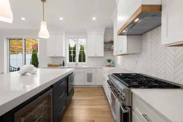a kitchen with kitchen island granite countertop stainless steel appliances a sink stove and cabinets
