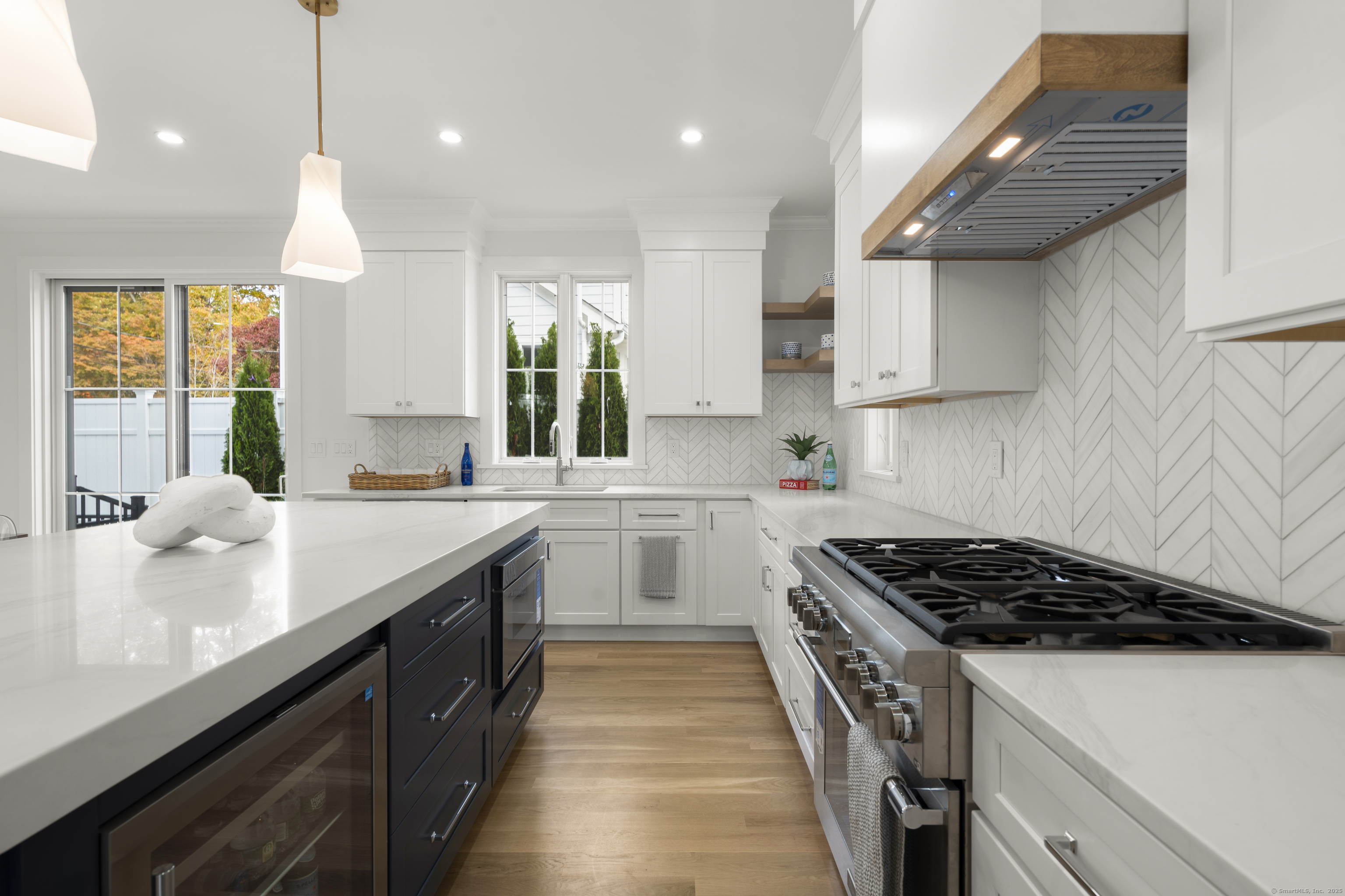706 Judd Street Fairfield, CT 06824 - Photo 12 of 40 a kitchen with kitchen island granite countertop stainless steel appliances a sink stove and cabinets