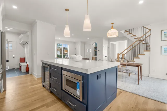 a kitchen with a stove and a wooden floor