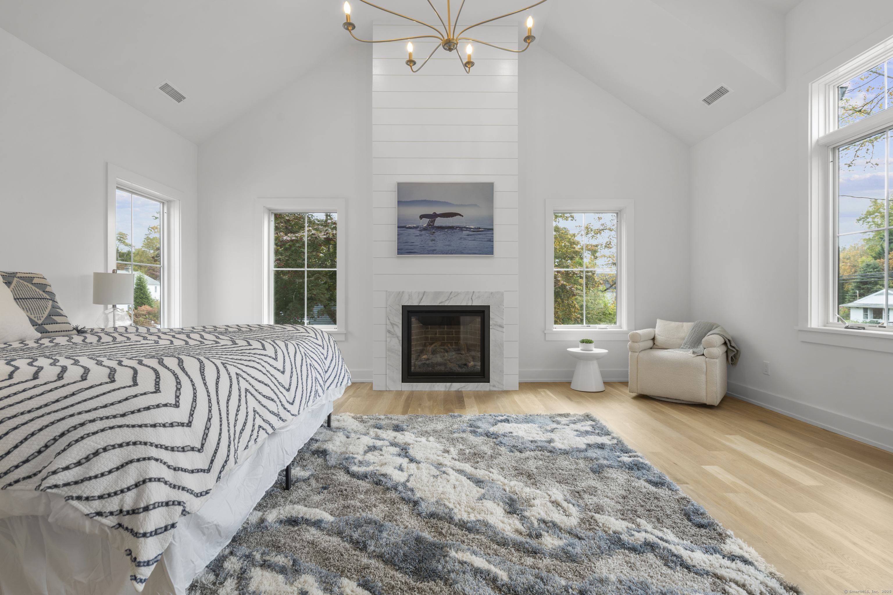 706 Judd Street Fairfield, CT 06824 - Photo 16 of 40 a spacious bedroom with a bed and a couch