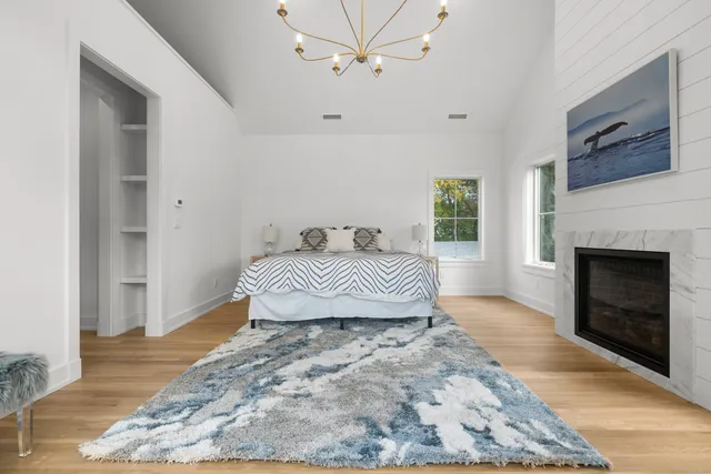 a bedroom with a bed and a fireplace