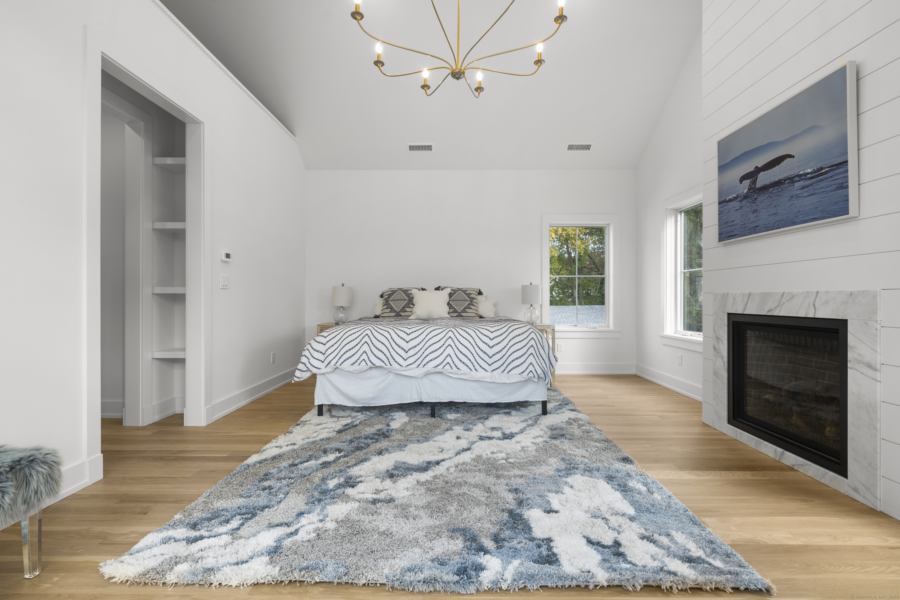 706 Judd Street Fairfield, CT 06824 - Photo 17 of 40 a bedroom with a bed and a fireplace