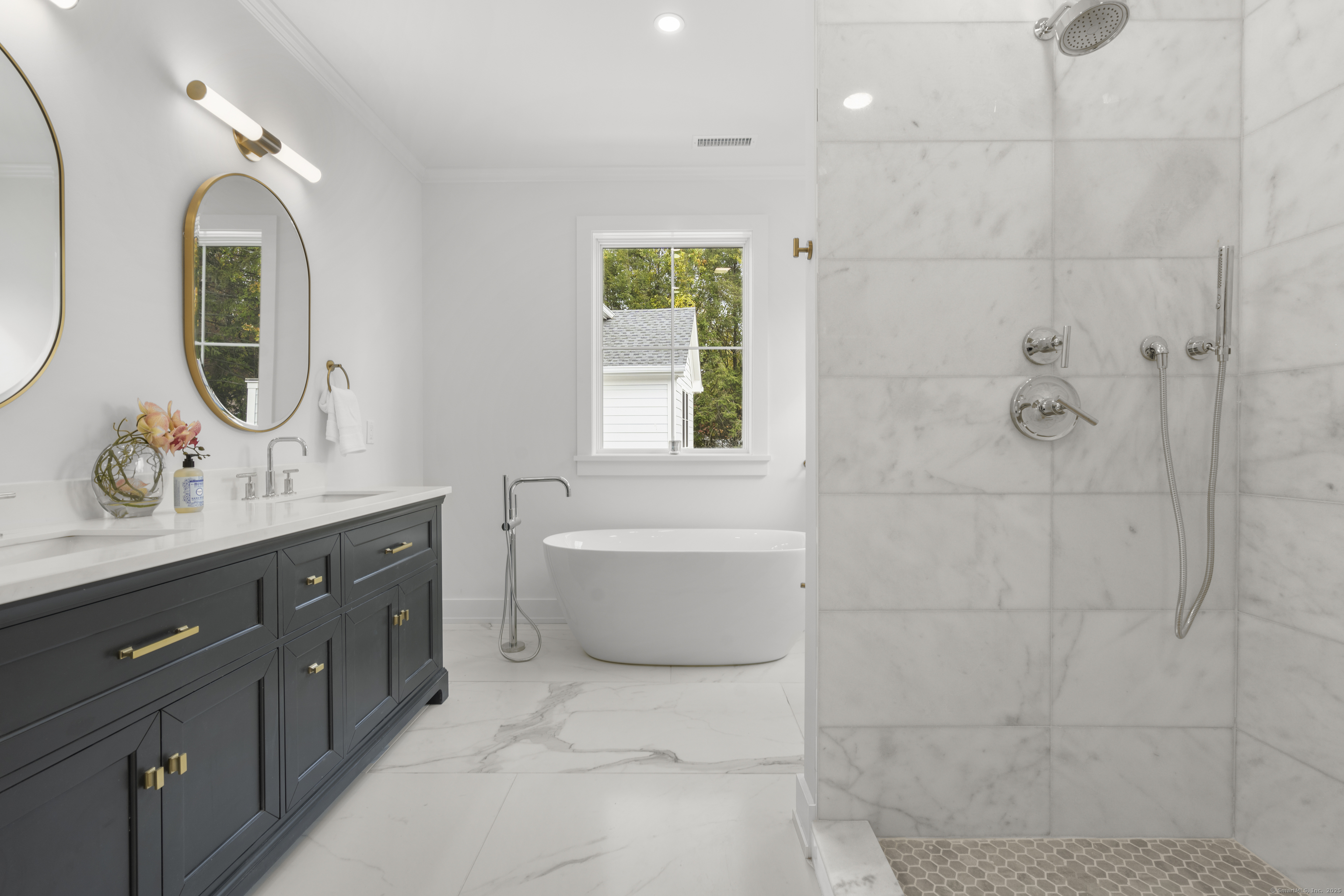 706 Judd Street Fairfield, CT 06824 - Photo 19 of 40 a spacious bathroom with a double vanity sink toilet mirror and bathtub