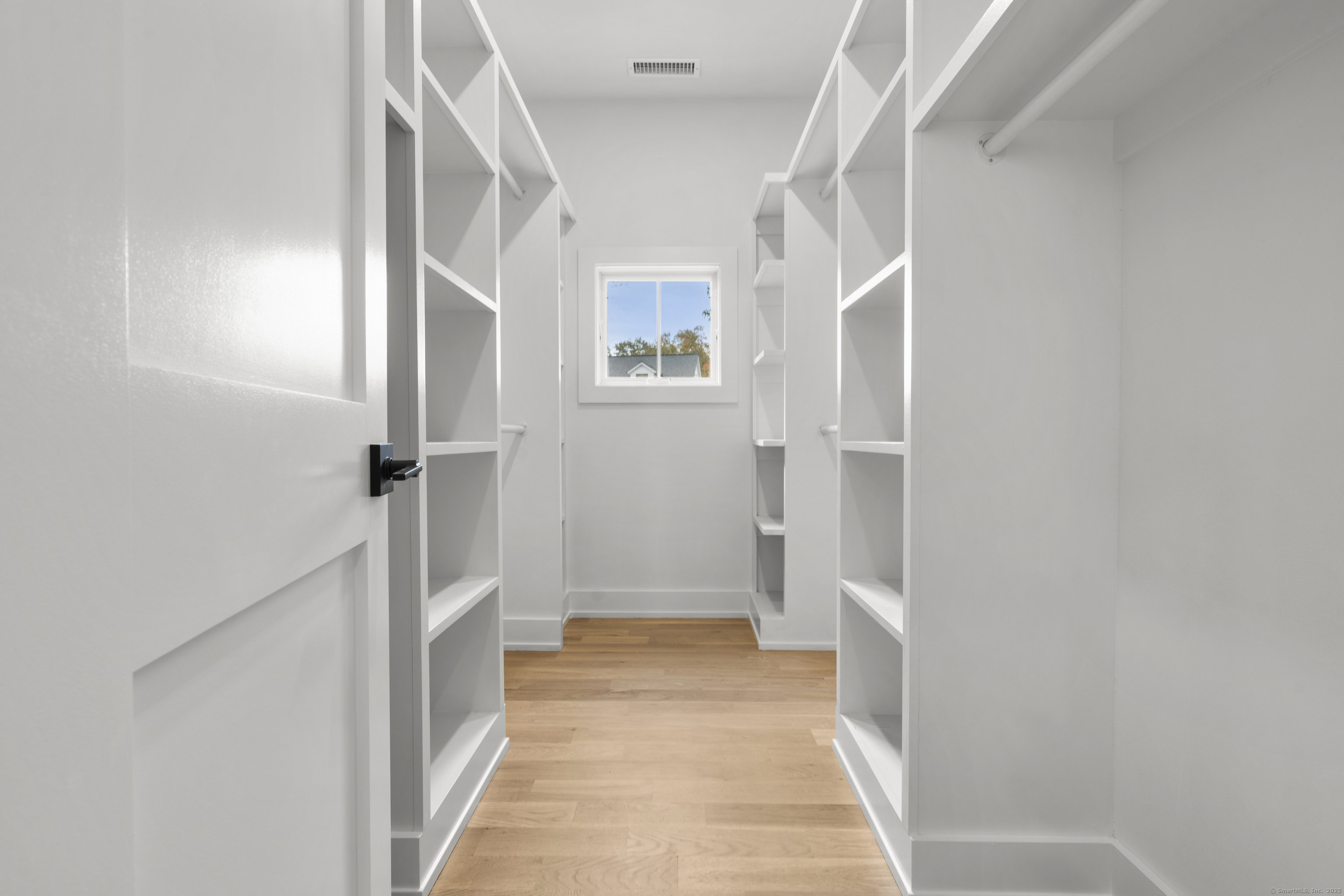 706 Judd Street Fairfield, CT 06824 - Photo 20 of 40 a view of a hallway with wooden floor and staircase