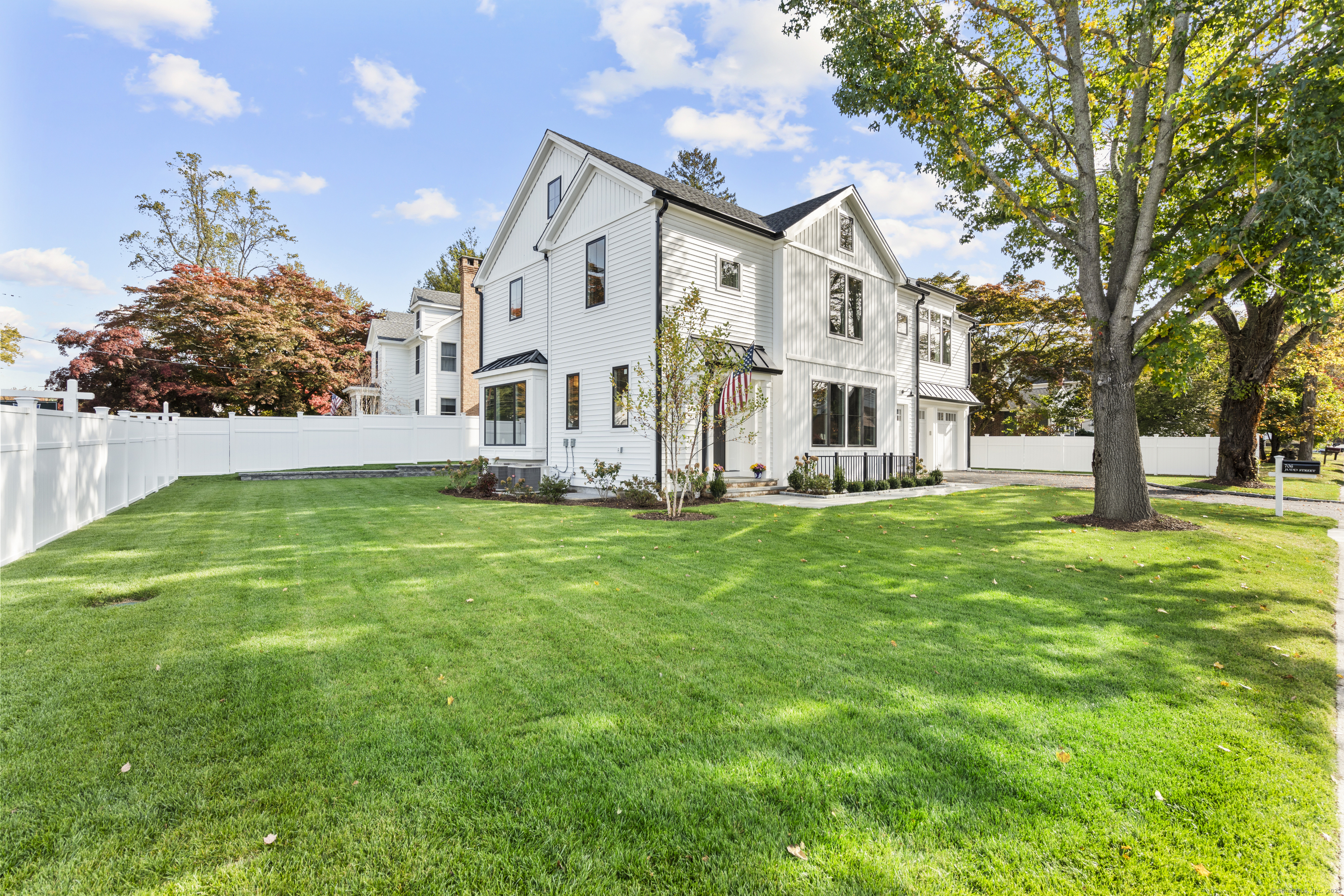 706 Judd Street Fairfield, CT 06824 - Photo 2 of 40 a view of a white house with a big yard and large trees