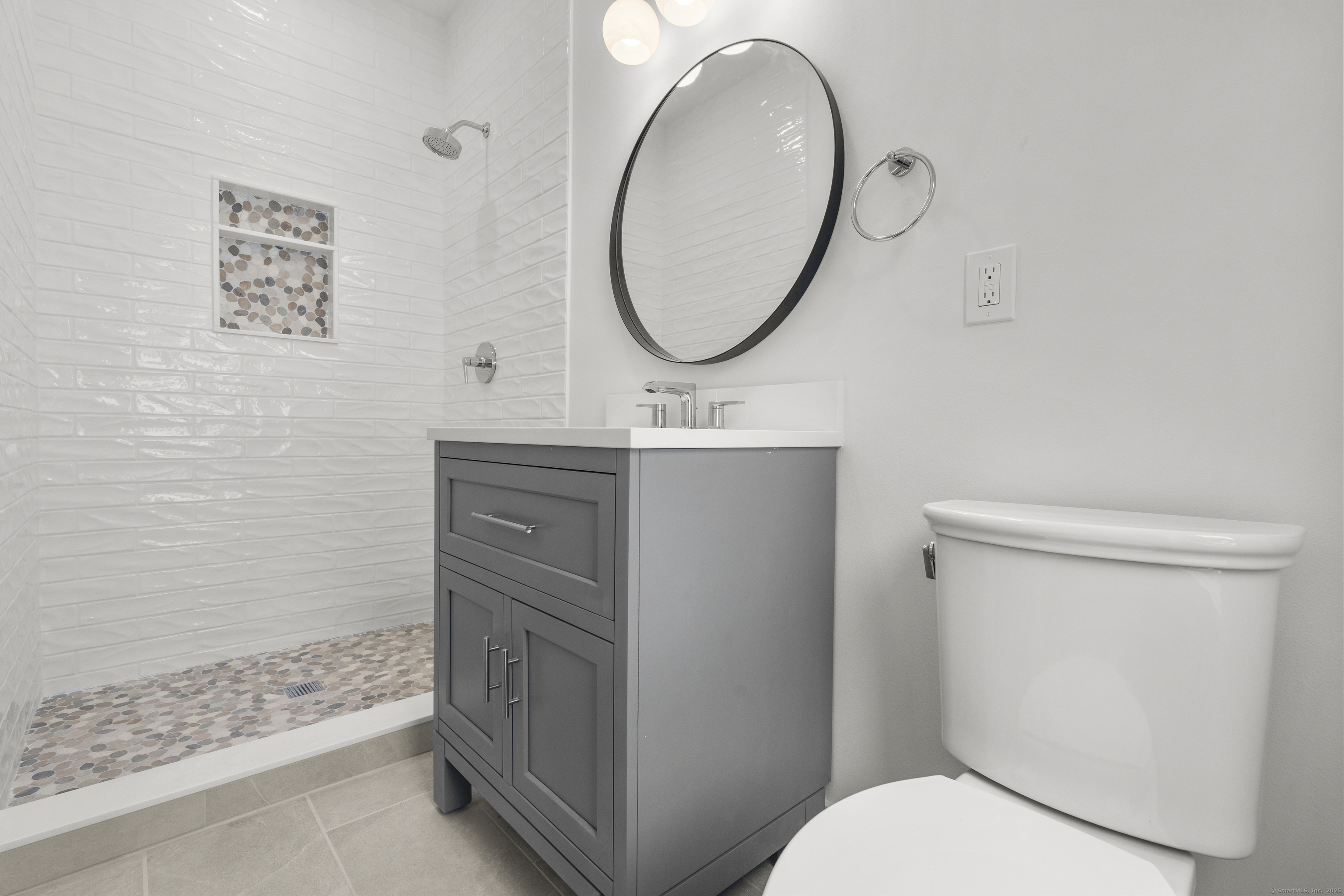 706 Judd Street Fairfield, CT 06824 - Photo 26 of 40 a bathroom with a sink a toilet and a mirror