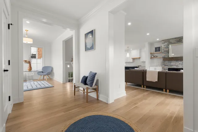 a open kitchen with cabinets and wooden floor
