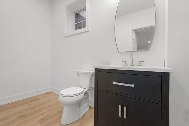 a bathroom with a sink toilet and mirror