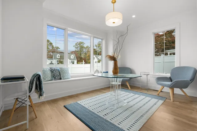 a living room with furniture rug and window