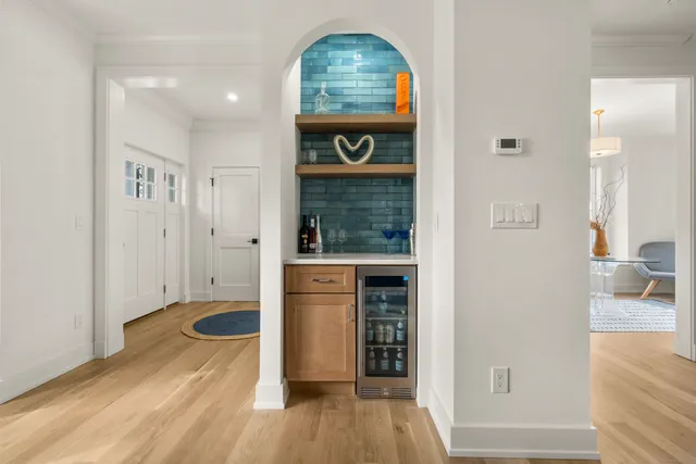 an entryway with wooden floor and a living room