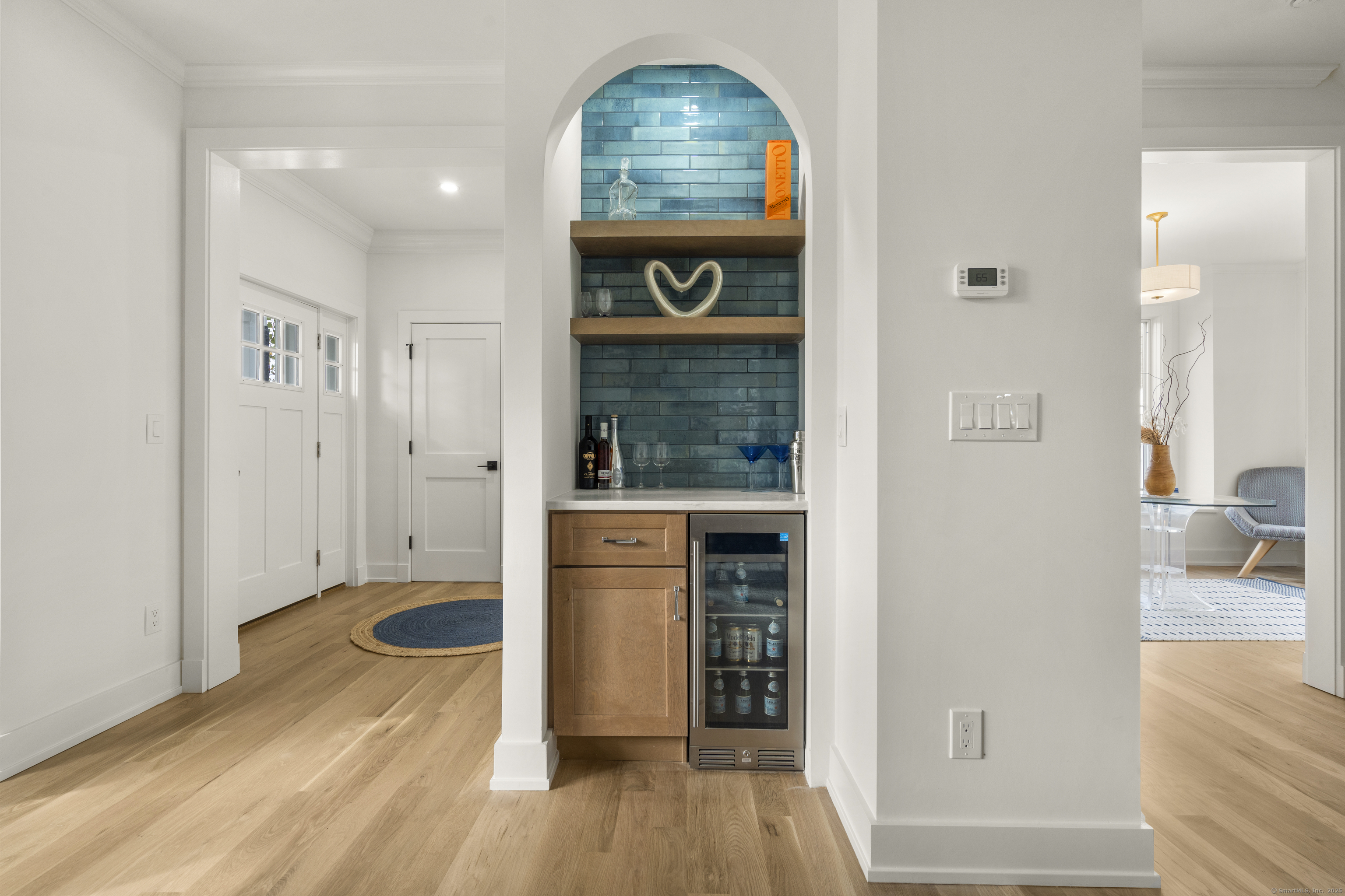 706 Judd Street Fairfield, CT 06824 - Photo 7 of 40 an entryway with wooden floor and a living room