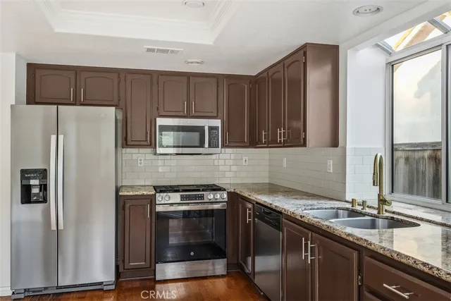 a kitchen with a sink stove and refrigerator