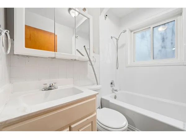 a bathroom with a sink a toilet and a bathtub