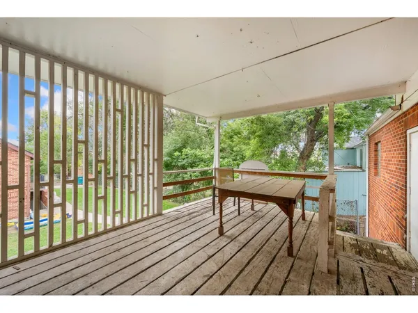 a balcony with wooden floor and outdoor space