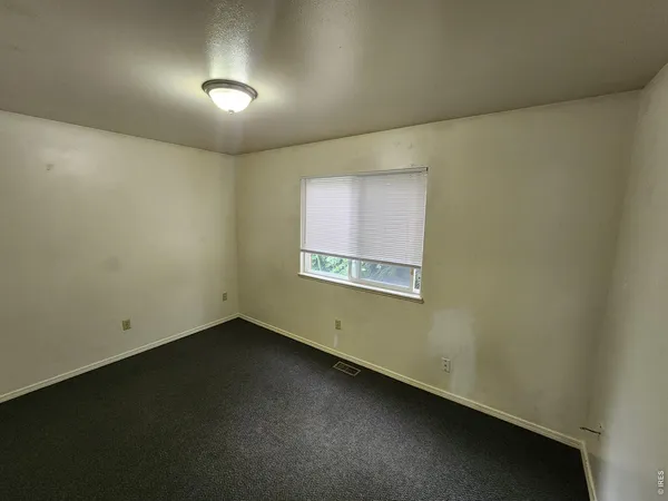 an empty room with a empty space and windows