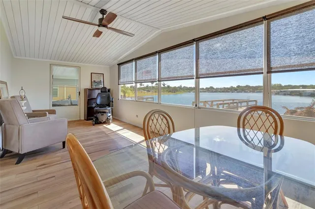 a dining room with furniture a chandelier and wooden floor