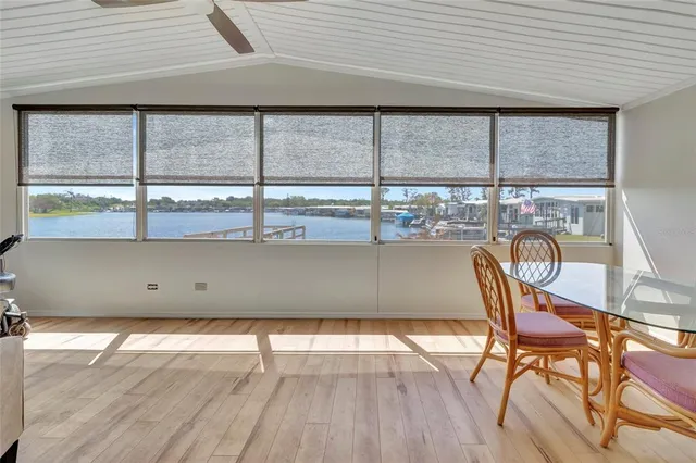 a floor to ceiling window with wooden floor