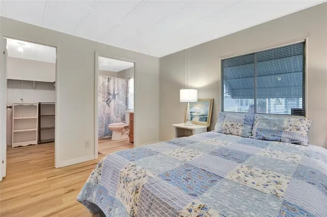 a spacious bedroom with a large bed and a dresser