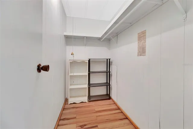 a view of a room with wooden floor